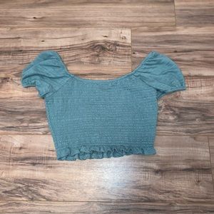 blue cropped off the shoulder top